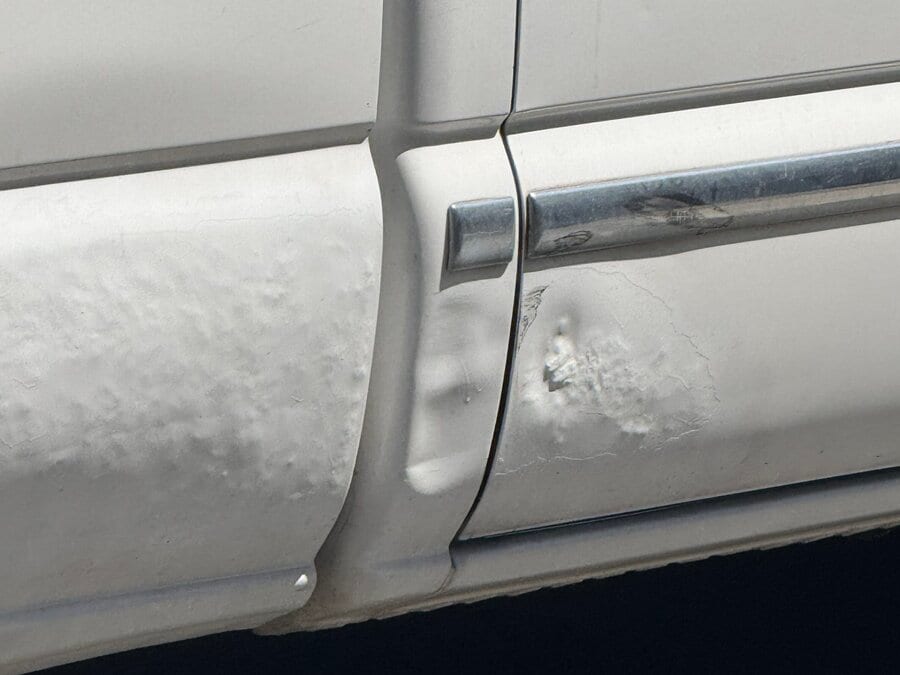 Vehicle panel with parking lot mobile PDR filler failing and lifting the factory paint