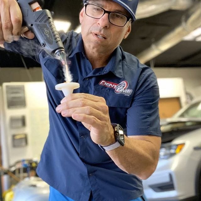 Glue pulling technique demonstrated during paintless dent repair training at Dent Time