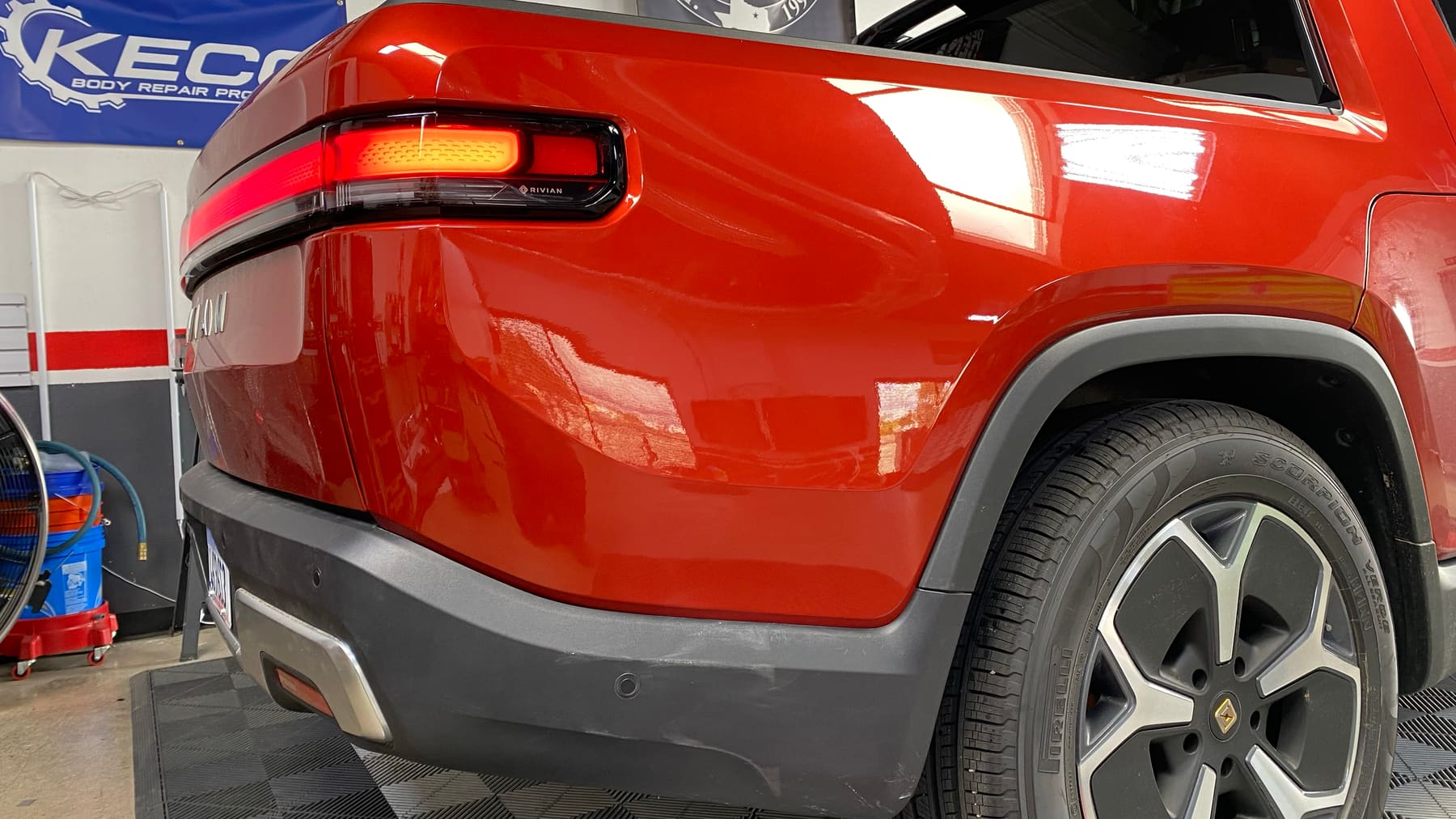 Rivian quarter panel after advanced large dent repair, factory finish restored, San Diego