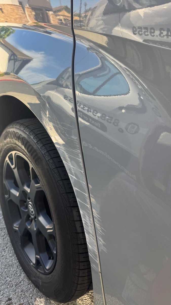 Long scrape down the rear quarter panel and sliding door of a gray Toyota before mobile repair in San Diego